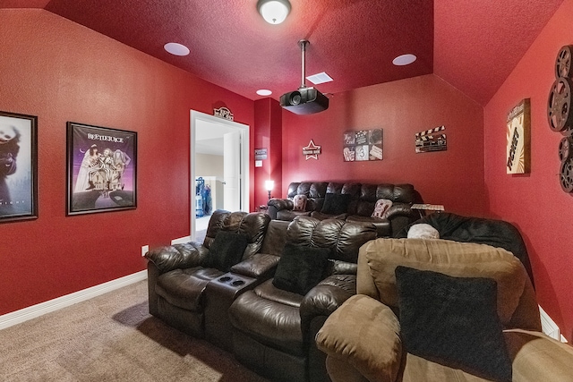 home theater room featuring lofted ceiling, a textured ceiling, and carpet floors