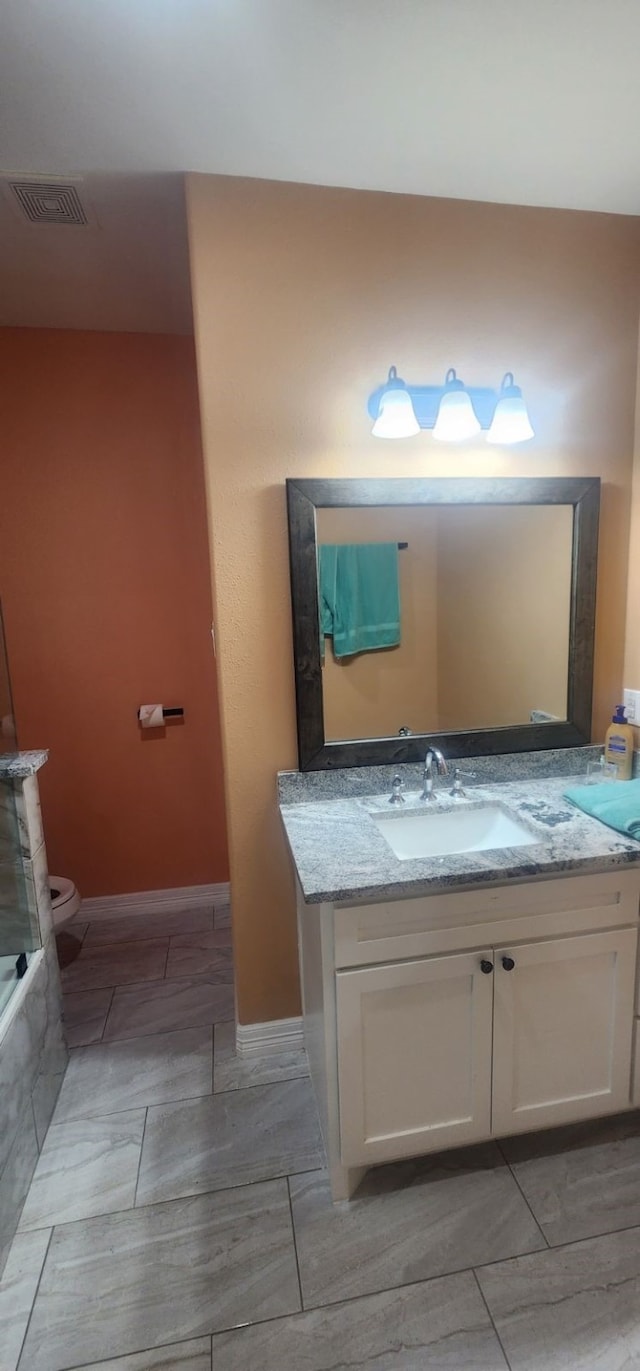 bathroom with toilet and vanity