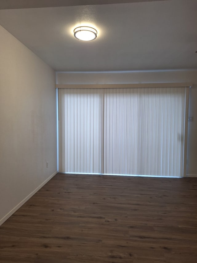 spare room featuring dark hardwood / wood-style flooring