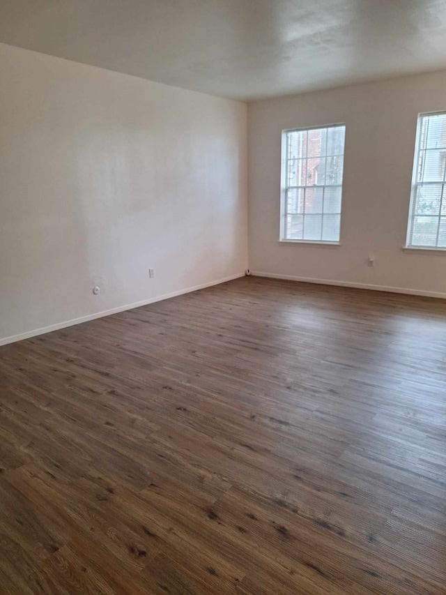 unfurnished room featuring dark hardwood / wood-style floors