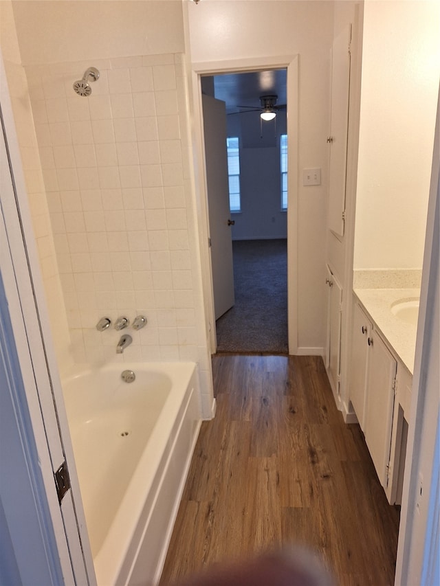 bathroom featuring tiled shower / bath, vanity, and hardwood / wood-style flooring