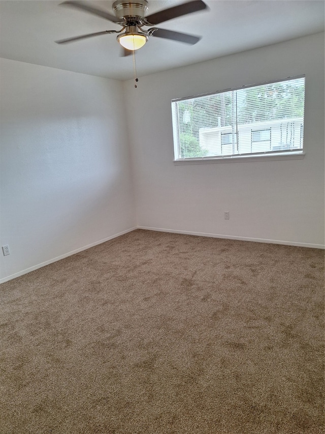 empty room featuring ceiling fan and carpet floors