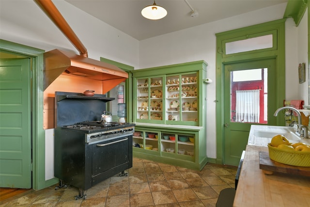 kitchen featuring black gas stove, green cabinetry, and sink