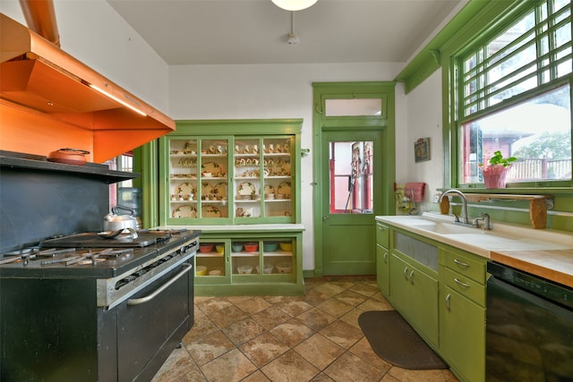 kitchen featuring black appliances, island exhaust hood, green cabinetry, and sink