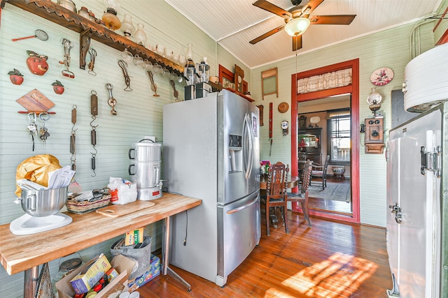 kitchen featuring dark hardwood / wood-style flooring, butcher block countertops, stainless steel fridge, wood walls, and ceiling fan