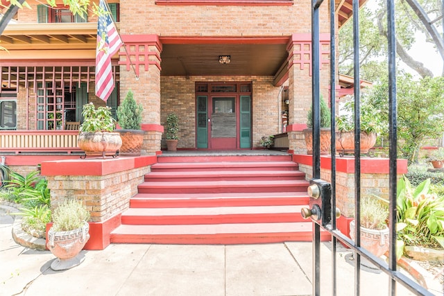 doorway to property featuring covered porch