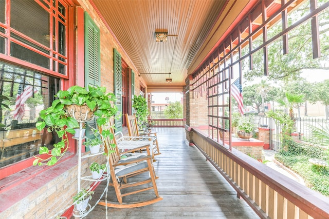 wooden terrace featuring covered porch