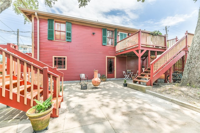 rear view of house featuring a patio and a deck