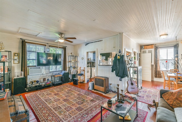 living room with wood-type flooring, cooling unit, and ceiling fan