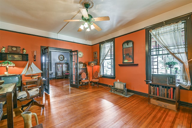 office space with cooling unit, ceiling fan, and hardwood / wood-style flooring