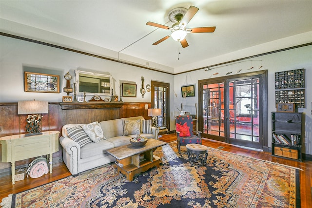 living room featuring wood-type flooring and ceiling fan