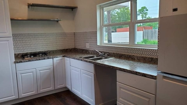 kitchen featuring a healthy amount of sunlight, white fridge, and white cabinets