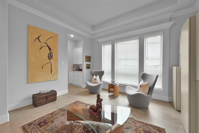 living area with light wood-style flooring and baseboards