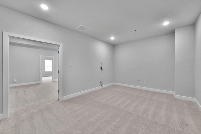 empty room with recessed lighting, visible vents, and light colored carpet