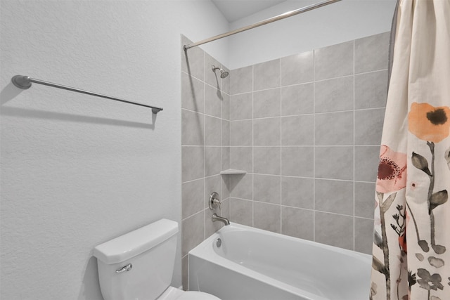 full bath with shower / tub combo, a textured wall, and toilet