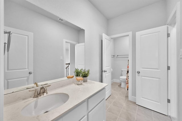 full bath with visible vents, toilet, tile patterned flooring, and vanity