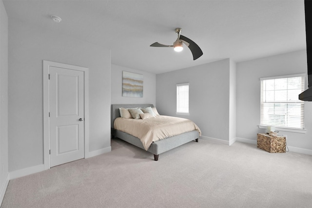 carpeted bedroom featuring ceiling fan and baseboards