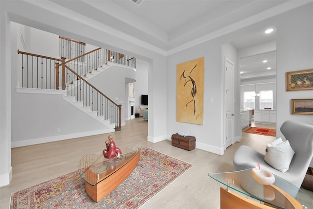 entrance foyer with recessed lighting, wood finished floors, baseboards, and stairs