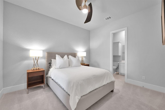 bedroom featuring ceiling fan, connected bathroom, light colored carpet, visible vents, and baseboards