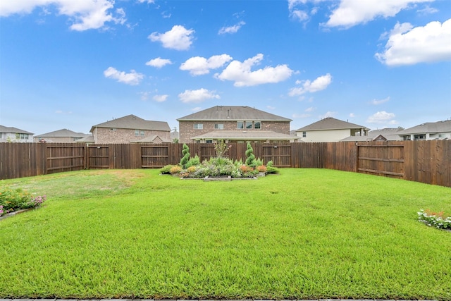 view of yard with a fenced backyard and a residential view