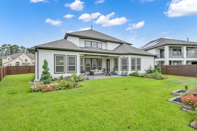 back of house with a yard, outdoor lounge area, a patio area, and a fenced backyard