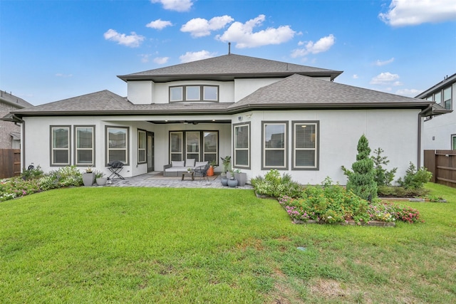 rear view of property featuring a patio area, fence, and a yard