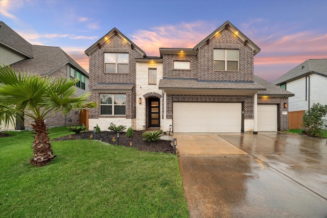 view of front of home featuring a yard and a garage