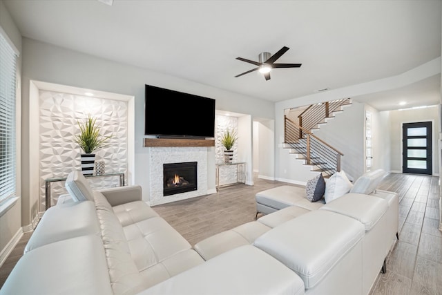 living room featuring ceiling fan and light hardwood / wood-style floors