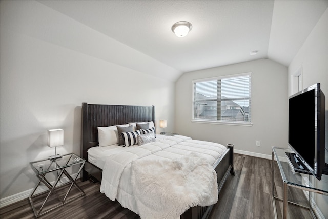 bedroom with dark wood-type flooring and lofted ceiling