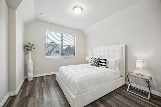 bedroom featuring lofted ceiling and dark wood-type flooring