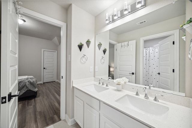 bathroom with vanity, walk in shower, and hardwood / wood-style flooring