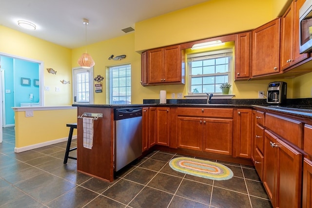 kitchen featuring dark tile patterned floors, stainless steel appliances, sink, kitchen peninsula, and pendant lighting