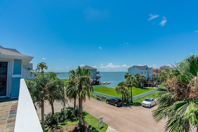 view of community featuring a water view and a lawn