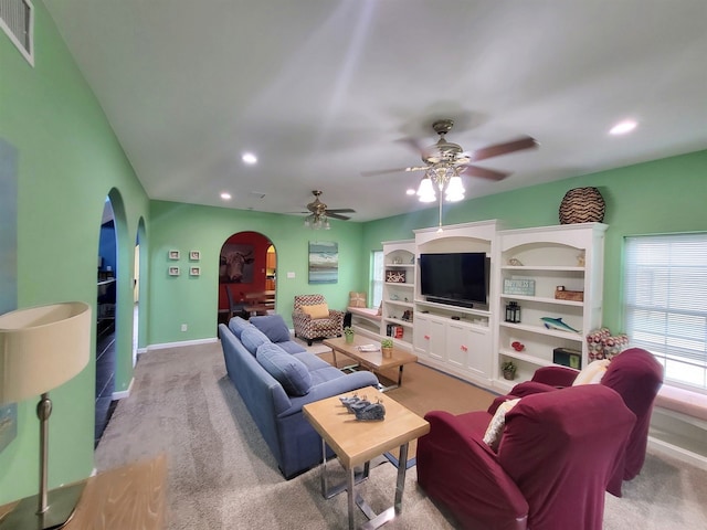 living room with ceiling fan and carpet floors