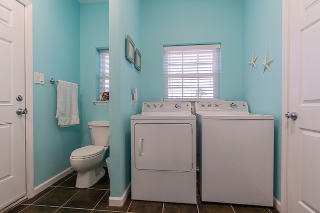 washroom featuring washer and dryer and dark tile patterned floors