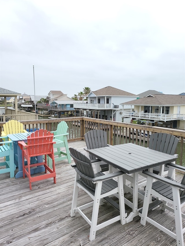 22921 Chiquita St, Galveston, TX 77554 - deck featuring outdoor dining space and a residential view