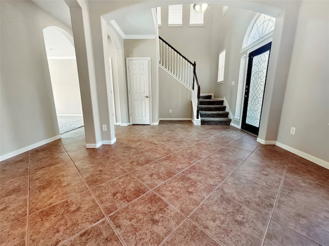 foyer featuring crown molding and tile patterned floors