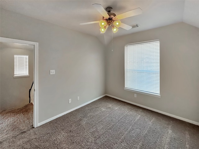 carpeted empty room featuring lofted ceiling and ceiling fan