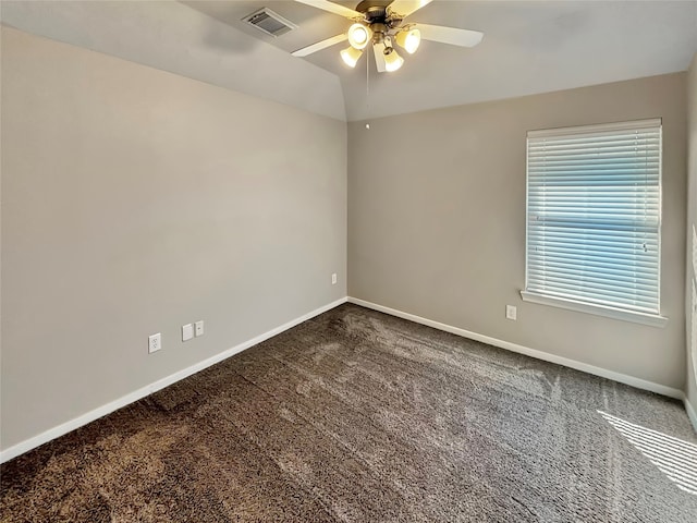 spare room with lofted ceiling, ceiling fan, and carpet