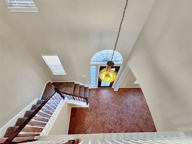 interior space with tile patterned floors and a towering ceiling