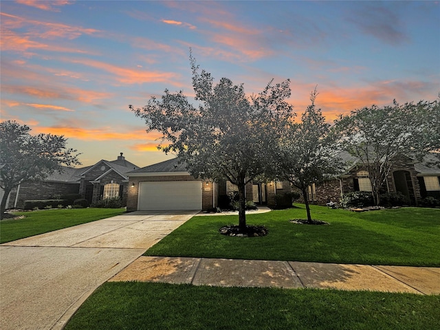 view of front of house with a yard and a garage