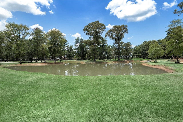 exterior space featuring a yard and a water view