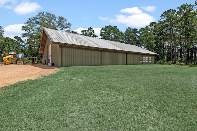 exterior space featuring a yard, an outbuilding, and a playground