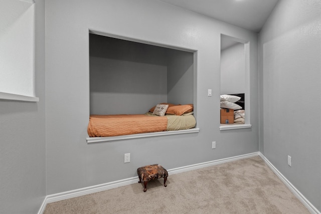 interior space featuring light carpet and vaulted ceiling