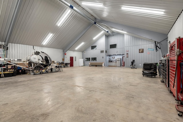 garage featuring wood walls and a workshop area