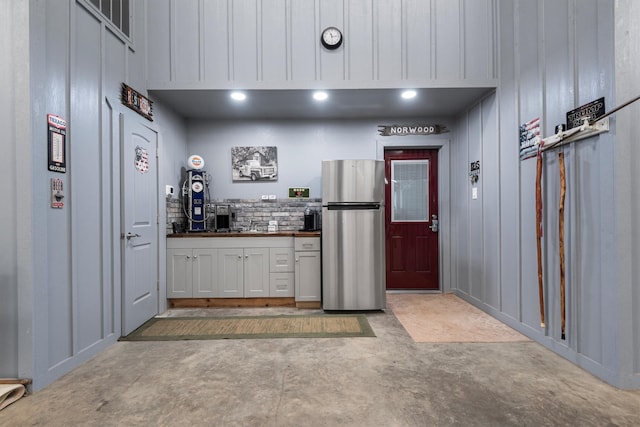 kitchen featuring white cabinetry and stainless steel refrigerator