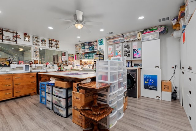 kitchen featuring washer / clothes dryer, ceiling fan, and light wood-type flooring