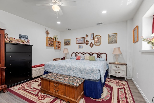 bedroom with ceiling fan and hardwood / wood-style flooring