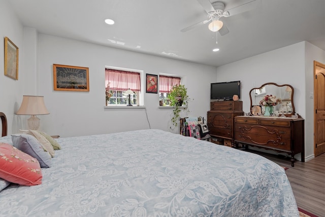 bedroom with hardwood / wood-style flooring and ceiling fan