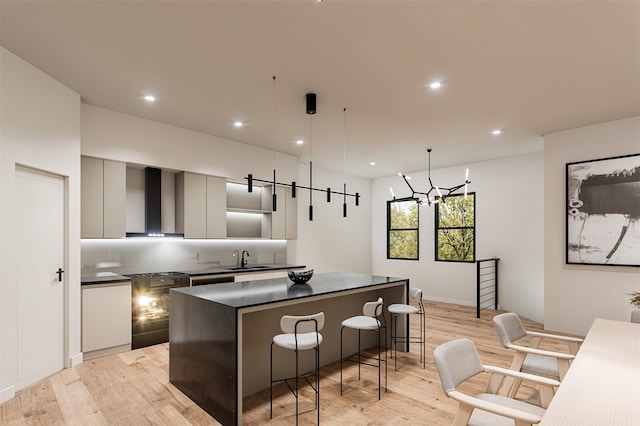 kitchen featuring gray cabinetry, a center island, light hardwood / wood-style flooring, and sink